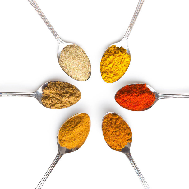 Various spices in spoons. - Foto, afbeelding