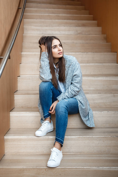 pensive girl   sitting on staircase - Фото, изображение