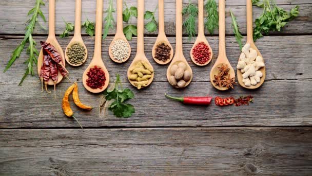 Spices and fresh herbs on a wooden table - Footage, Video