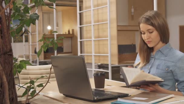 Girl closes the book at the working hub - Video