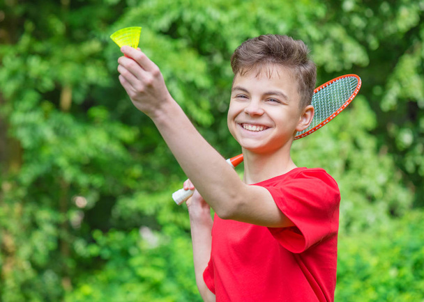 Teen boy playing badminton in park - Photo, Image