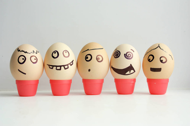 Eggs with painted face. Concept of the first - Foto, Imagem