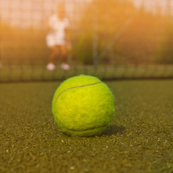 Tennis ball and silhouette of tennis player - Photo, Image