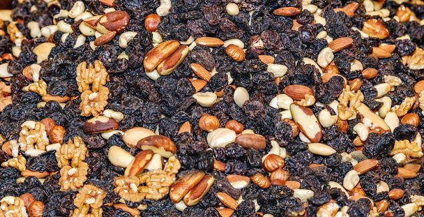 Mixture of nuts with raisins. Brazilian, walnut, cashew, hazelnut, almonds. Food for students - Zdjęcie, obraz