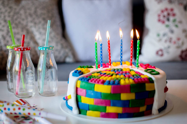 Colorful cake with candles and balloons - 写真・画像