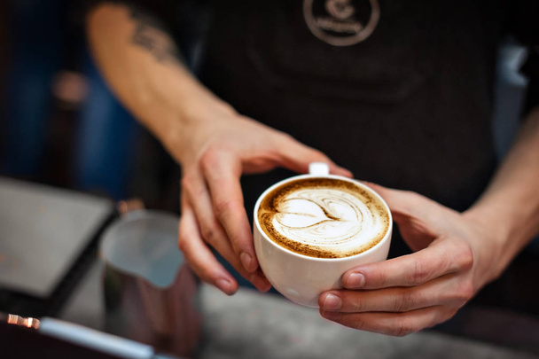 Barista creating latte art  - Foto, afbeelding