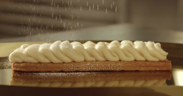 sugar powder falling on a cream on puff pastry base - Footage, Video