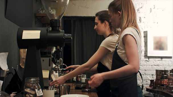 Two young female barista working in coffee shop, pareparing coffee - Valokuva, kuva