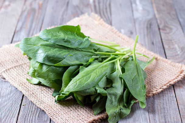 Bunch of fresh sorrel on a wooden background - Photo, Image