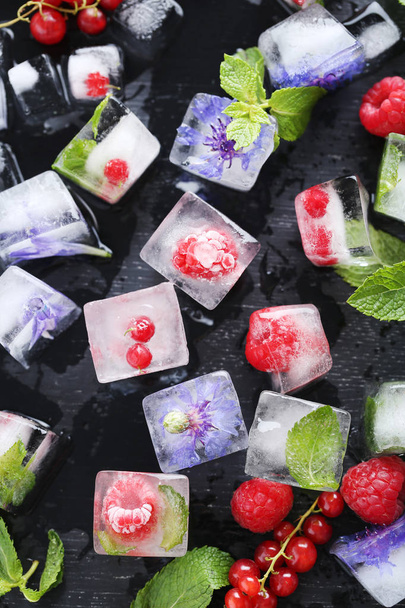 Ice cubes with raspberries and mint leaves - Fotó, kép