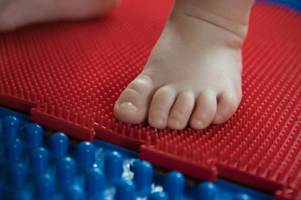 Child's foot on a yoga mat - Photo, Image