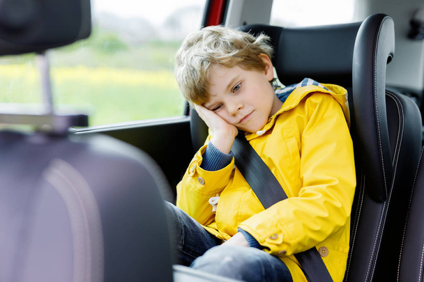 Tired preschool kid boy sitting in car during traffic jam - Foto, imagen