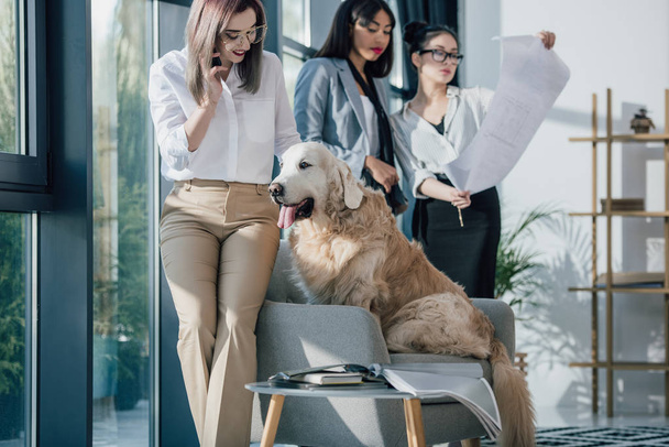 Businesswomen with dog in office  - Photo, image