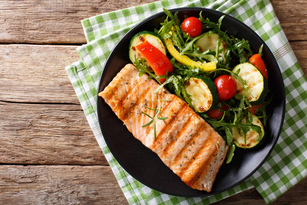 Salmon grilled with zucchini salad, arugula, pepper and tomatoes - Photo, Image