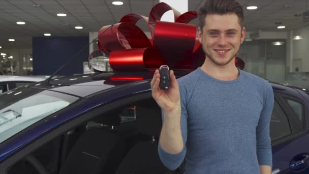 Male customer poses near the car at the showroom - Footage, Video