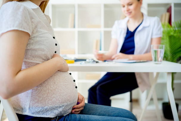Pregnant woman visiting doctor - Photo, image