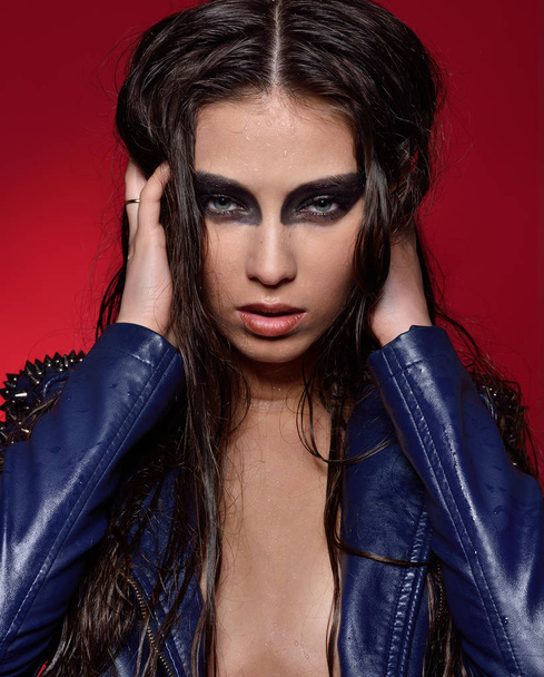 Sexy woman in leather jacket and panties with stage make up. - Photo, Image