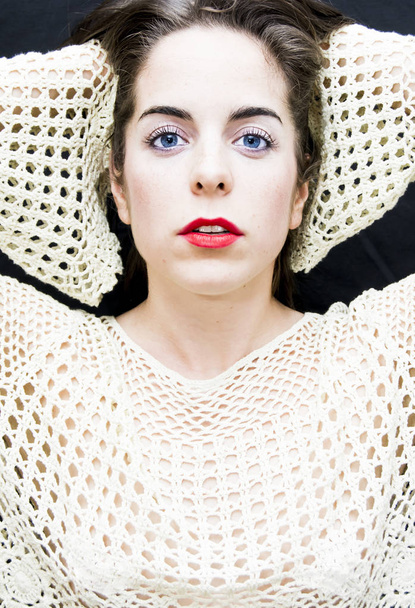 Portrait of a beautiful Blue-eyed woman on black background - Fotoğraf, Görsel
