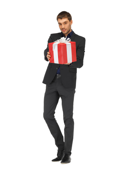 Handsome man in suit with a gift box - Fotoğraf, Görsel