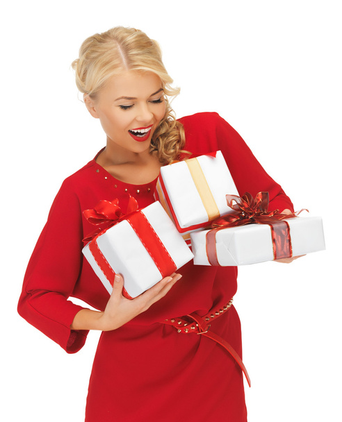 Lovely woman in red dress with gift boxes - Foto, immagini