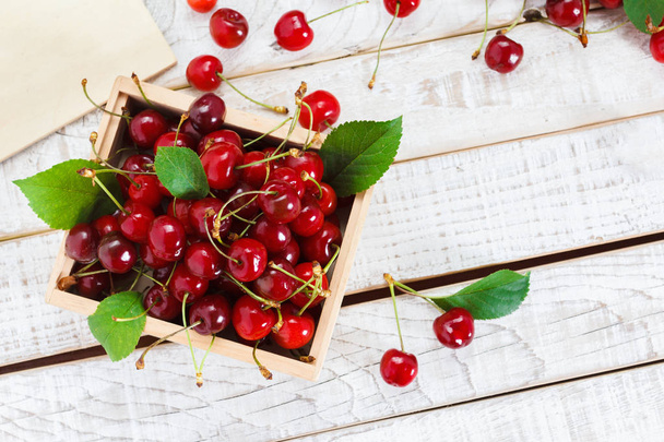 Ripe cherries on wooden table. View from above - Фото, изображение