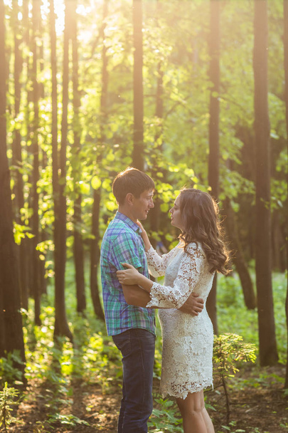 Portrait of a young romantic couple embracing each other on nature - Foto, immagini
