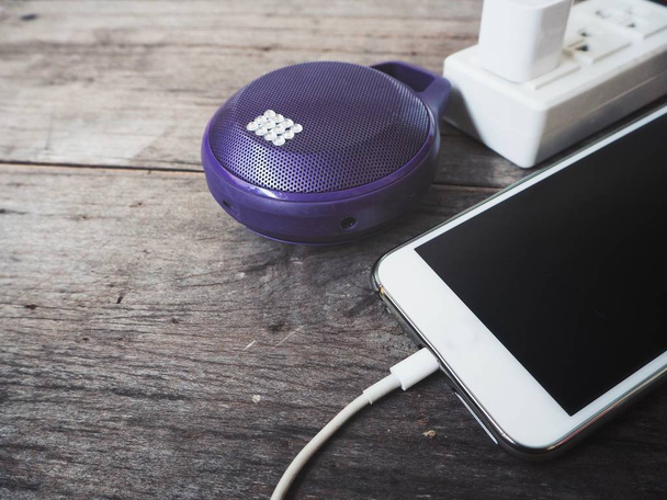 Smartphone charger with bluetooth speaker - Photo, Image