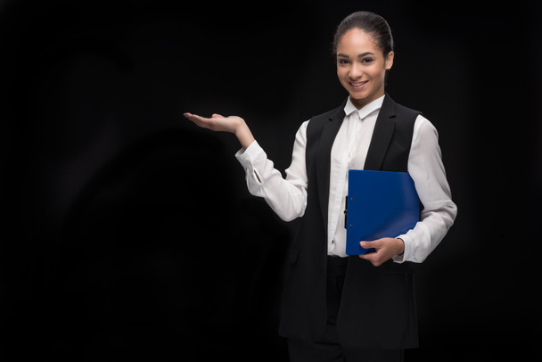 young businesswoman standing with clipboard - Photo, Image