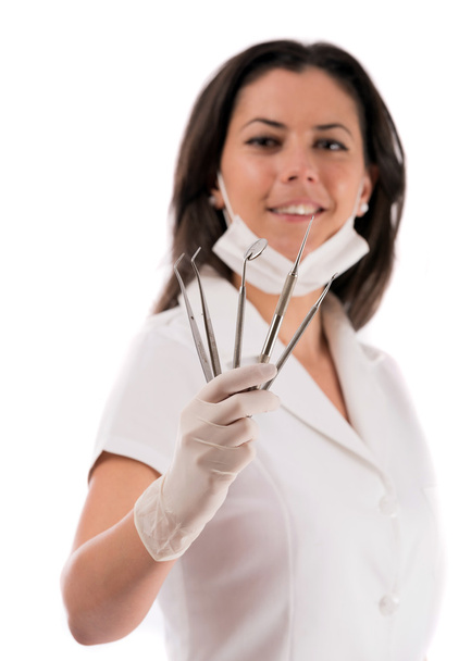 A young dentist with a tool on a white background - Photo, Image