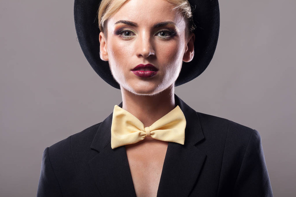 Portrait of woman wearing a suit and hat - Фото, зображення