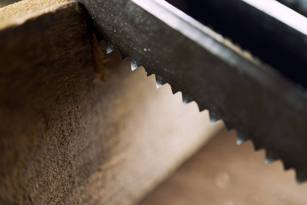 Knife with a blade saw (with teeth) saws a wooden block - 写真・画像