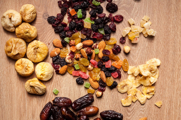 Mix of dried fruits on wooden background - Photo, Image