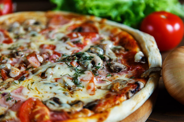 Delicious homemade pizza with mozzarella, mushrooms, tomatoes an - Fotografie, Obrázek