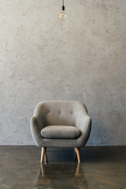 Grey armchair in empty room  - Фото, зображення