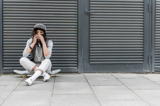 Stylish pleasant teenager is resting on street - Foto, Imagem