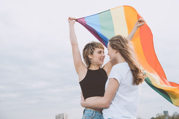 Homosexual couple with lgbt flag  - Photo, Image
