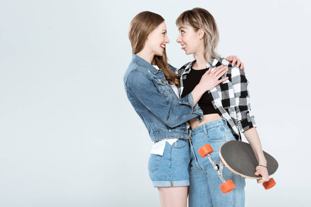 Lesbian couple with skateboard  - Фото, зображення