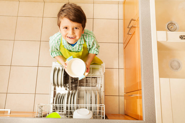 boy near dishwasher in kitchen - Фото, зображення