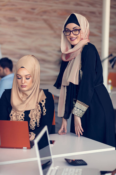 Two women with hijab in office. - 写真・画像