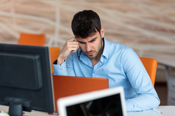 Worried businessman working in office - Photo, image