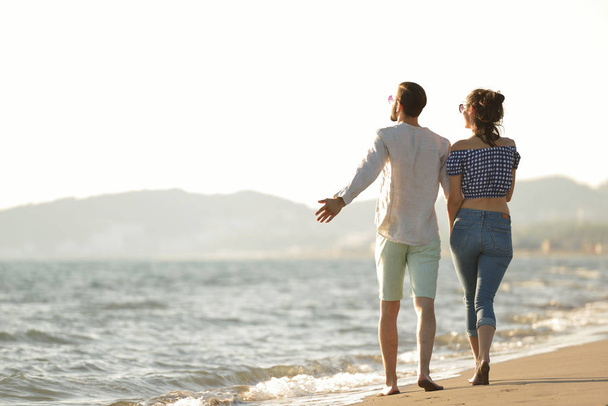 happy couple walking on the beach - Фото, изображение