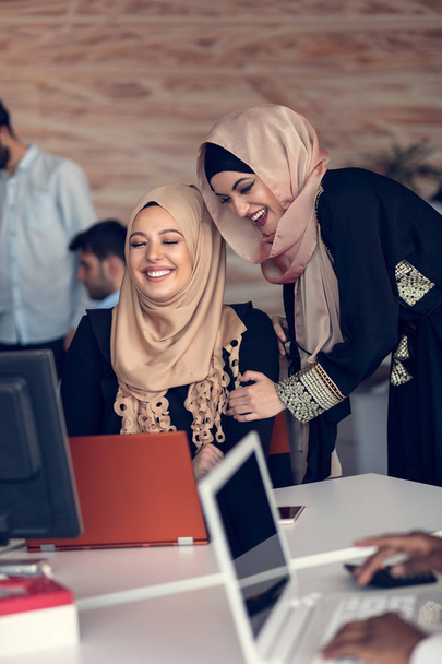 Two women with hijab in office. - 写真・画像