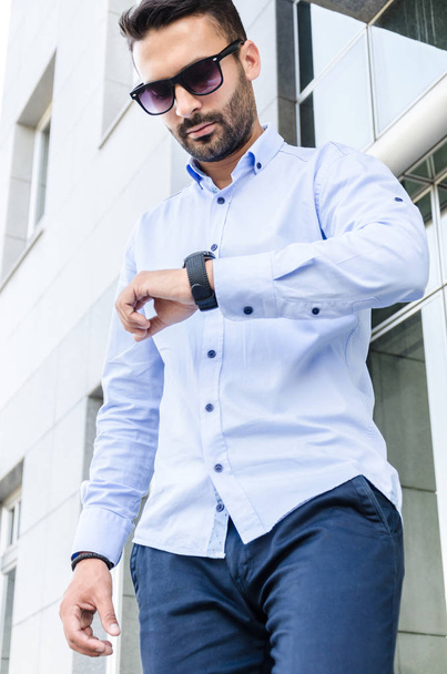young businessman looking at his watch - Fotó, kép