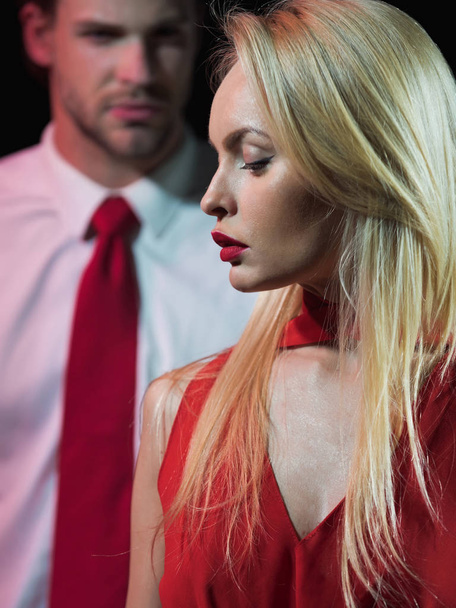couple in love of blonde woman in red and man - Fotó, kép
