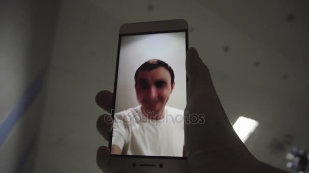 Using video chatting with man on smart phone - Felvétel, videó