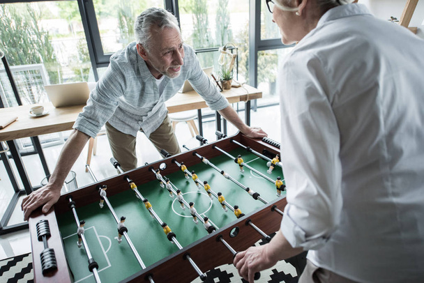colleagues playing foosball  - Photo, Image