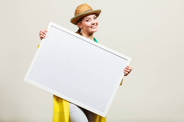 Happy cheerful woman holding blank white board - Photo, Image
