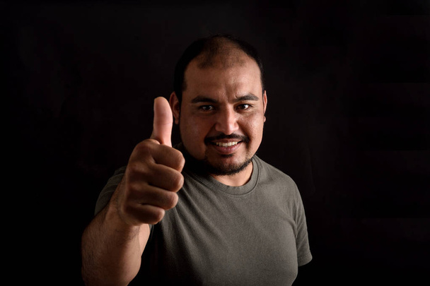 man doing the sign thumbs up on white background - Foto, Imagen