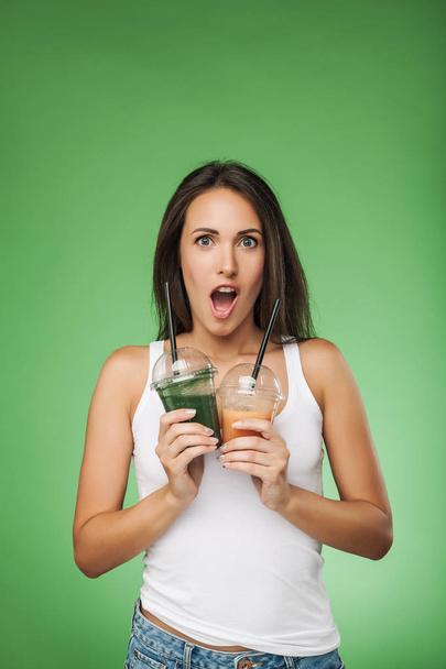 Young surprised woman holding smoothie - Zdjęcie, obraz