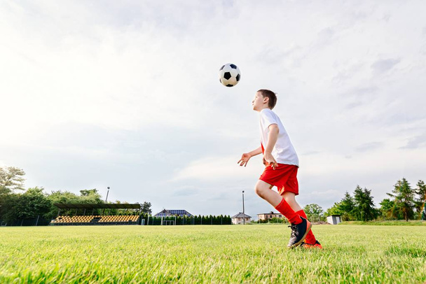 8 years old boy child playing football - Foto, Imagen